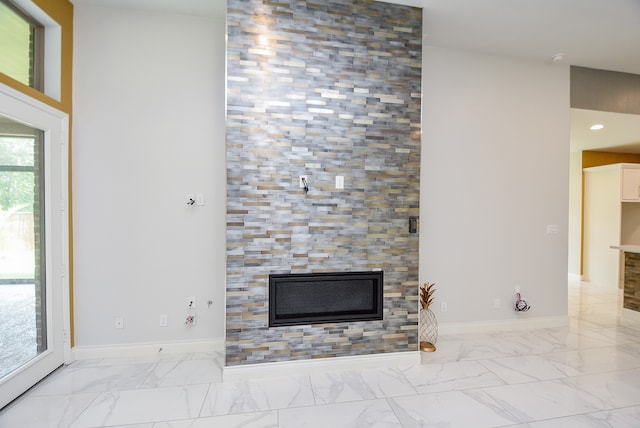 unfurnished living room with a tiled fireplace and light tile patterned floors