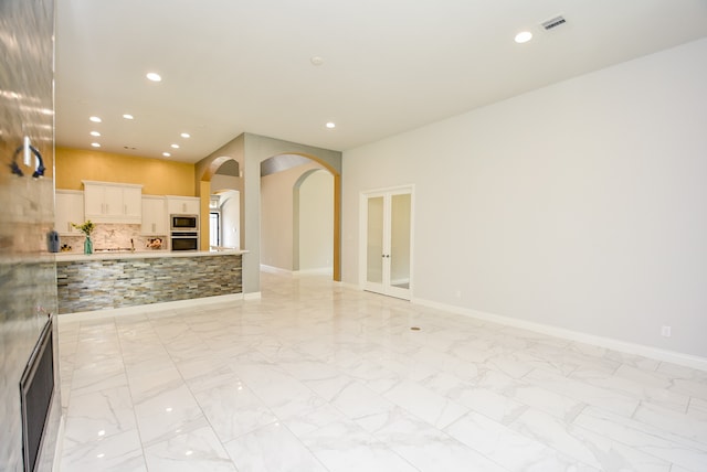 unfurnished living room with light tile patterned flooring