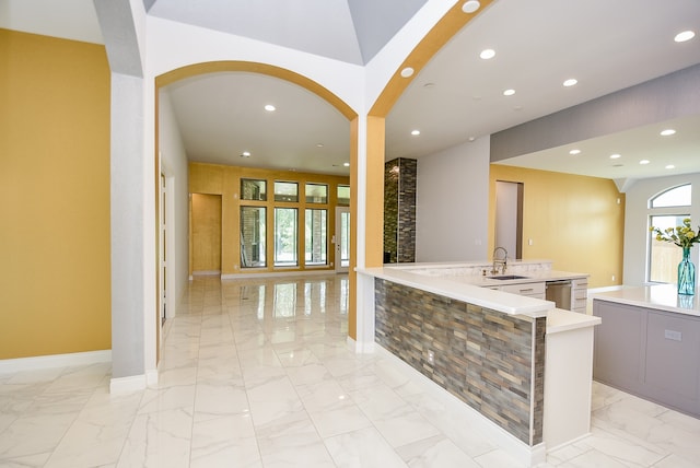 interior space with gray cabinets, light tile patterned floors, and sink