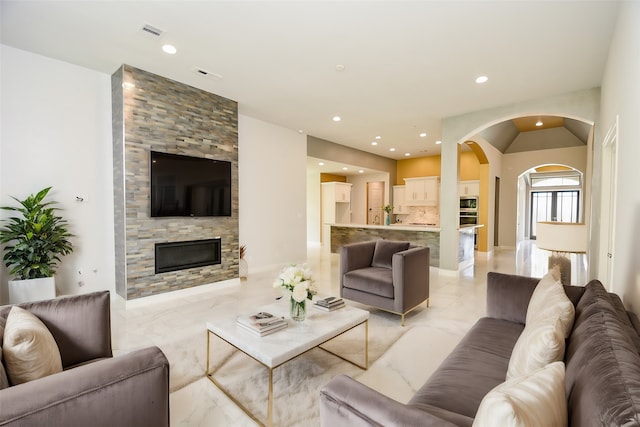 living room with light tile patterned flooring and a fireplace