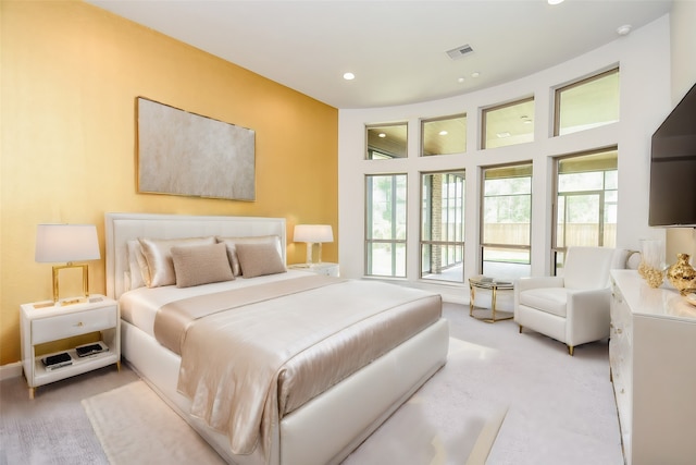 carpeted bedroom featuring multiple windows