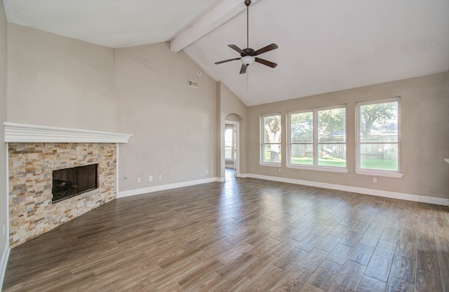 unfurnished living room featuring beamed ceiling, ceiling fan, a fireplace, and hardwood / wood-style flooring