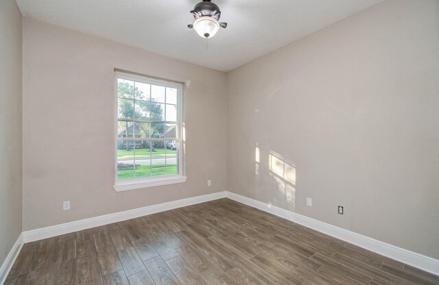 empty room with hardwood / wood-style floors