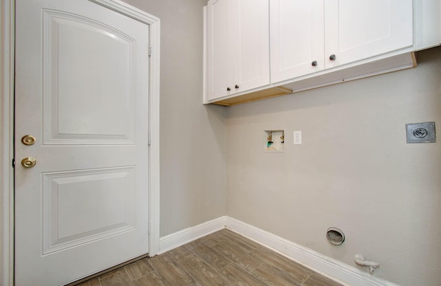 laundry area with cabinets, hookup for a gas dryer, washer hookup, electric dryer hookup, and light hardwood / wood-style flooring