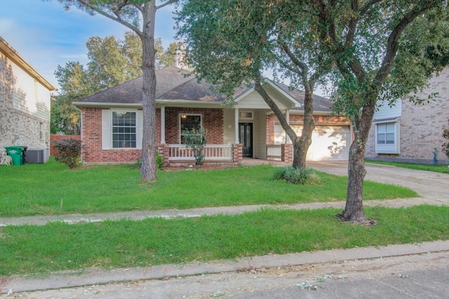 view of front of house featuring a front lawn, central AC, and a garage