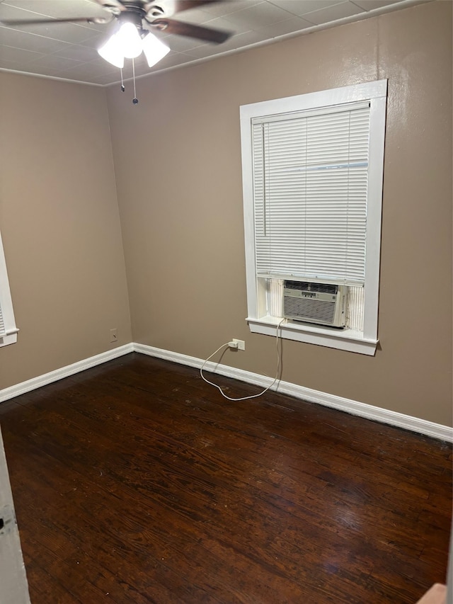 spare room with ceiling fan, cooling unit, and hardwood / wood-style flooring