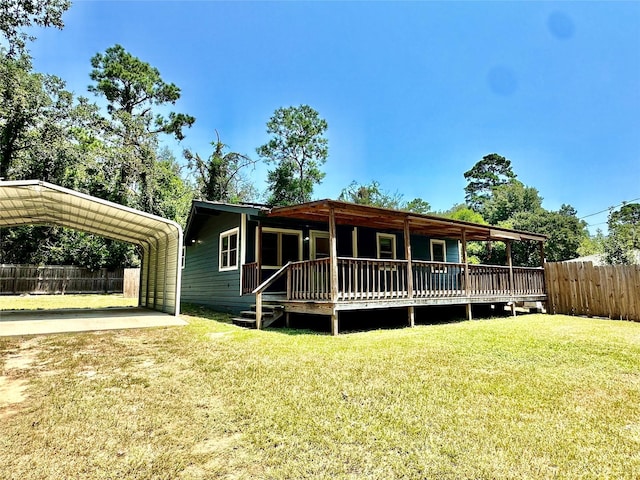 view of front of house with a carport, a deck, and a front lawn