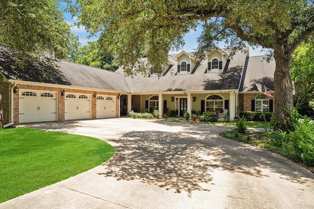 view of front of property with a front yard and a garage