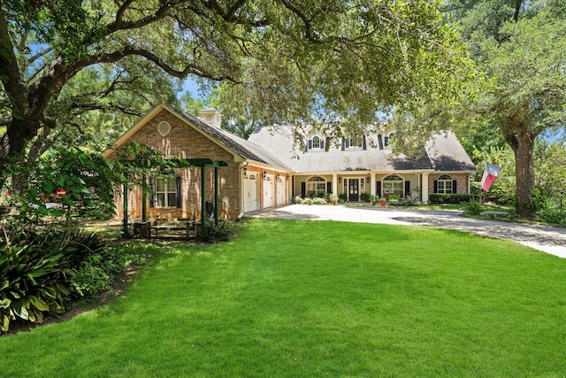 back of property featuring a lawn and a garage