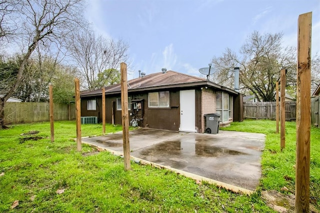 rear view of house with a lawn, a patio, and central air condition unit