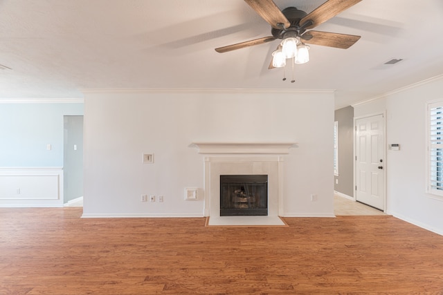 unfurnished living room with ceiling fan, light hardwood / wood-style flooring, and ornamental molding