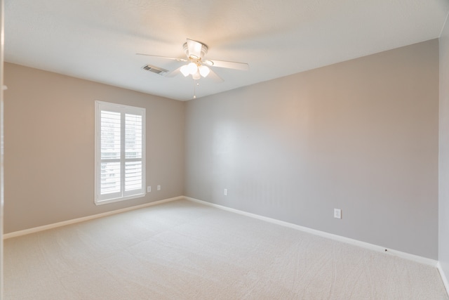 spare room with ceiling fan and carpet floors