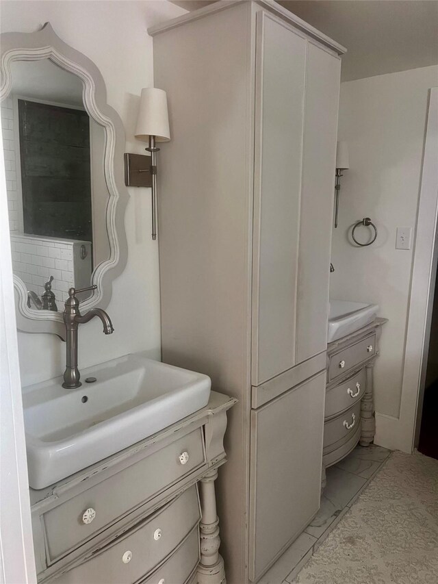 bathroom with tile patterned floors and vanity