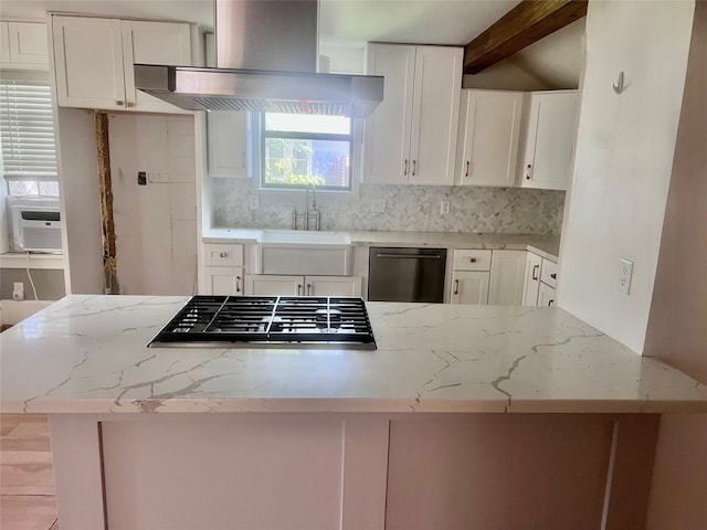 kitchen with stainless steel dishwasher, light stone countertops, white cabinetry, sink, and wall chimney exhaust hood