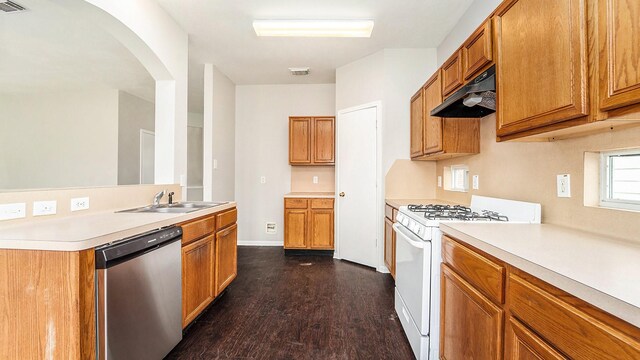 kitchen with sink, stainless steel dishwasher, dark hardwood / wood-style flooring, and white gas range oven