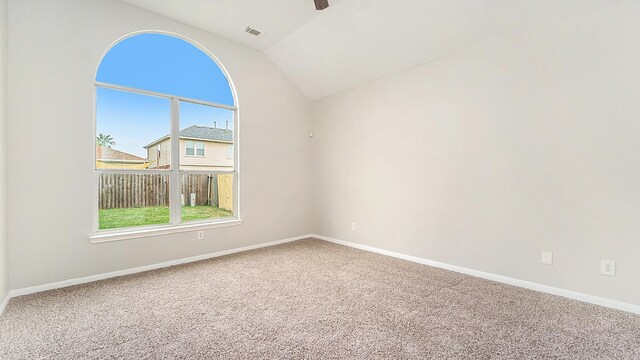 unfurnished room with carpet floors and vaulted ceiling