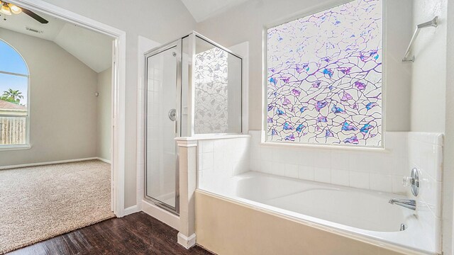 bathroom featuring ceiling fan, wood-type flooring, lofted ceiling, and independent shower and bath