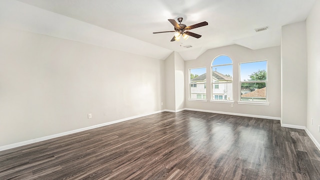 spare room with ceiling fan, dark wood-type flooring, and lofted ceiling