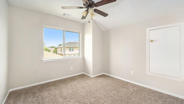 carpeted spare room with ceiling fan