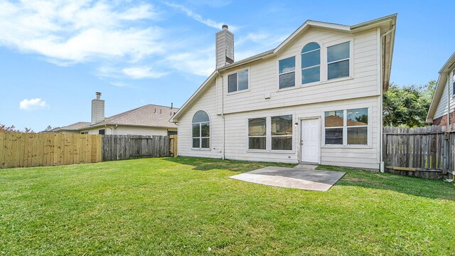 rear view of house with a yard