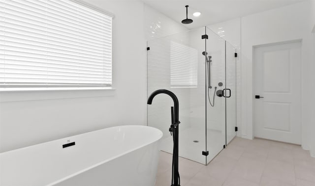 bathroom featuring tile patterned flooring and separate shower and tub