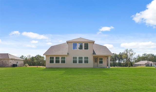 rear view of property with a lawn