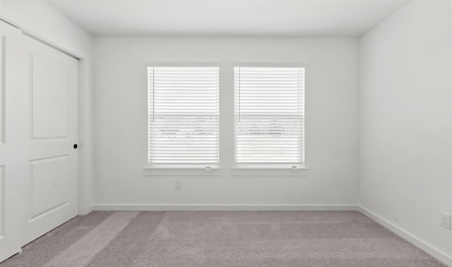 carpeted empty room featuring a wealth of natural light