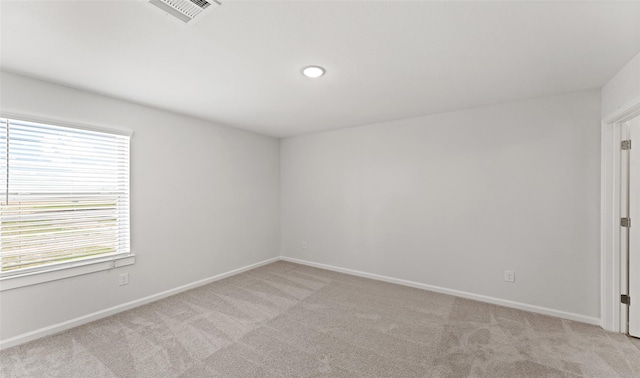 carpeted spare room with a wealth of natural light