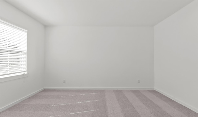 empty room with plenty of natural light and carpet