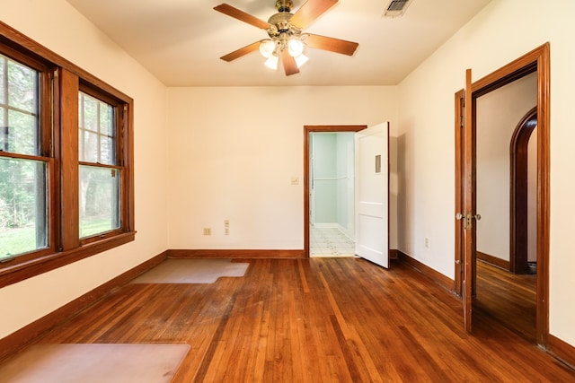 empty room featuring ceiling fan and hardwood / wood-style flooring