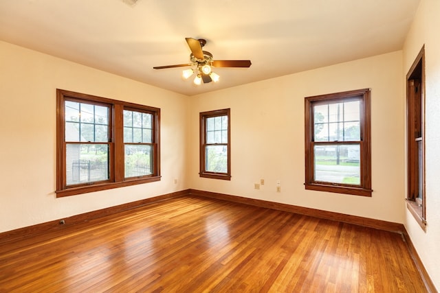 spare room with hardwood / wood-style floors and ceiling fan