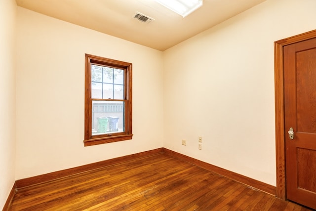 unfurnished room with hardwood / wood-style flooring