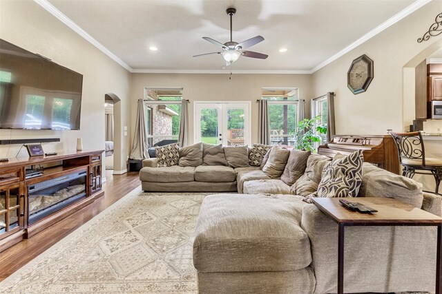 living room with french doors, ornamental molding, hardwood / wood-style floors, and ceiling fan