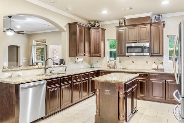 kitchen featuring light tile patterned flooring, appliances with stainless steel finishes, a wealth of natural light, and sink