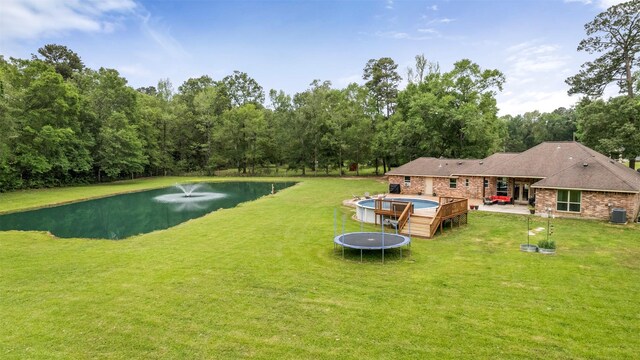 view of yard with a deck with water view