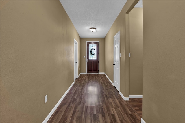 doorway featuring a textured ceiling and hardwood / wood-style floors