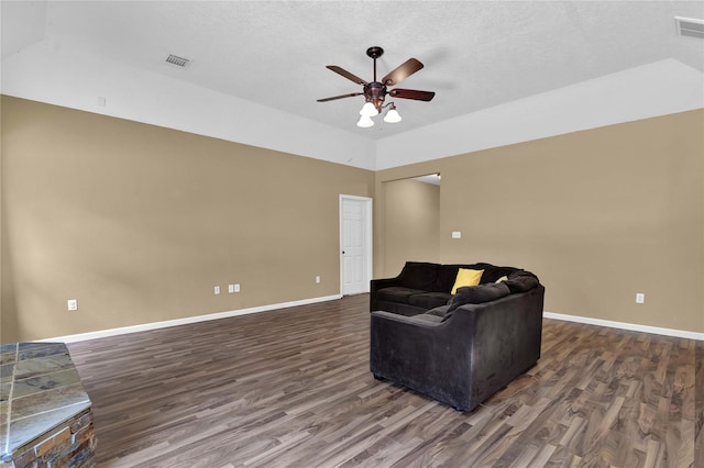 sitting room with ceiling fan, a textured ceiling, and wood-type flooring