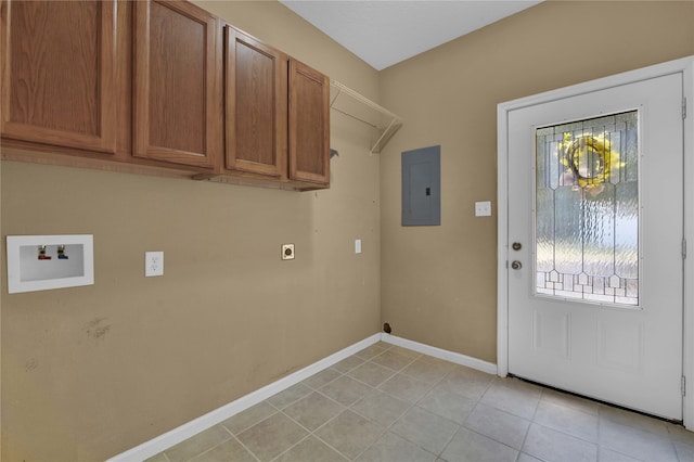 clothes washing area featuring washer hookup, electric panel, light tile patterned floors, and a wealth of natural light