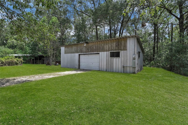 view of outbuilding featuring a yard and a garage