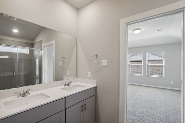 bathroom featuring vanity and a shower with shower door