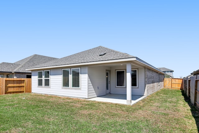 back of house featuring a patio and a lawn