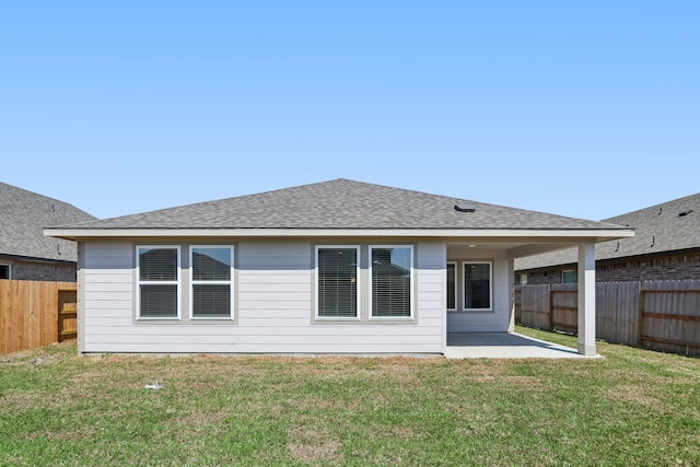 back of house featuring a patio and a yard