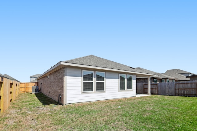 rear view of property with a yard