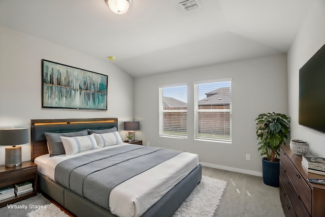 carpeted bedroom with vaulted ceiling