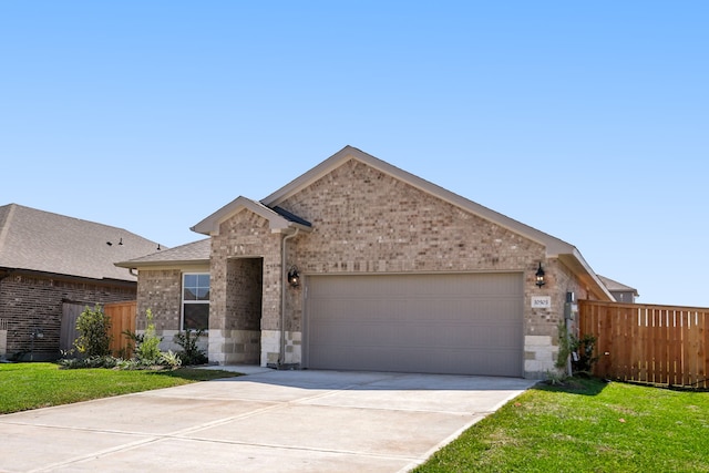 view of front of home with a garage and a front lawn