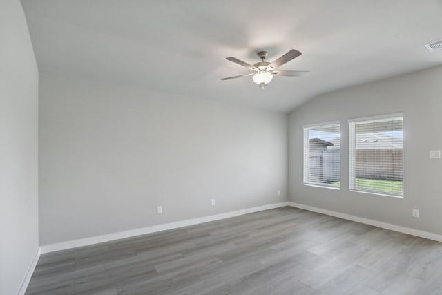 empty room with ceiling fan, wood-type flooring, and lofted ceiling