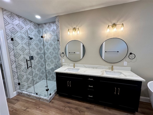 bathroom with vanity, hardwood / wood-style flooring, and a shower with shower door