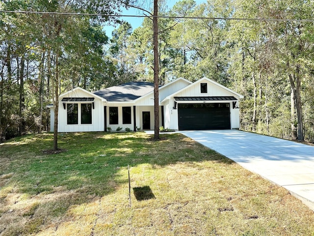 modern inspired farmhouse with a front lawn and a garage