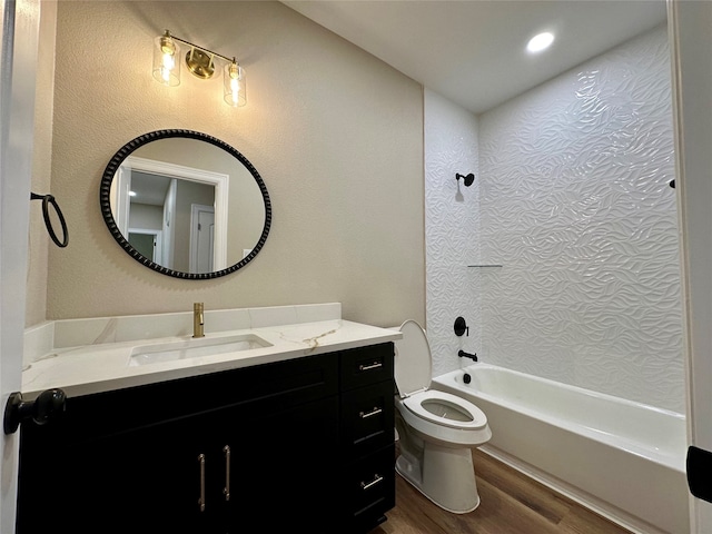 full bathroom featuring hardwood / wood-style floors, vanity, toilet, and shower / bath combination