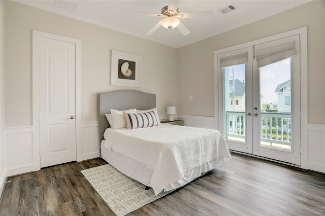 bedroom featuring dark hardwood / wood-style floors, access to exterior, multiple windows, and ceiling fan